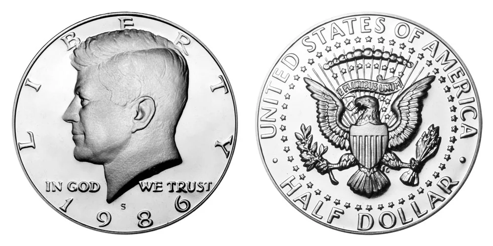 1986 Kennedy half dollar grading strip showing four condition tiers from worn to gem uncirculated